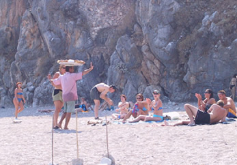 Man on beach -selling food